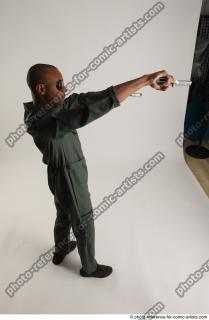 ERIC STANDING POSE WITH GUNS